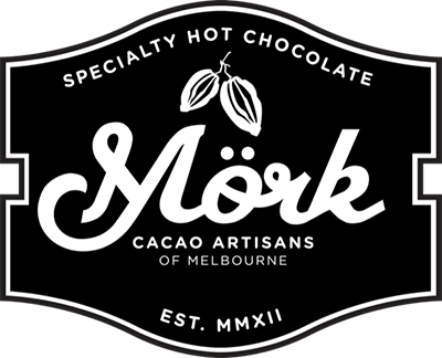 Black and white label reads: "Specialty Hot Chocolate. M&ouml;rk. Cacao Artisans of Melbourne. Est. MMXII," with two cacao pods illustrated above the word "M&ouml;rk.